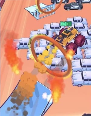 A monster truck jumping through a ring of fire onto a field of cars