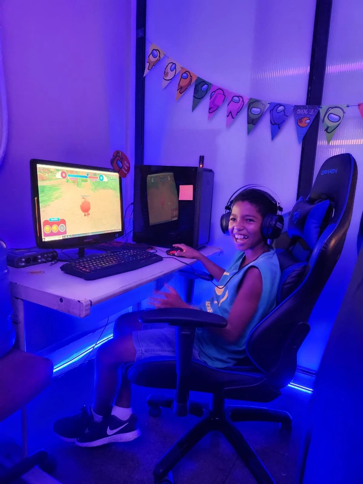 A smiling child with headphones playing Super Hacka Kids at the event
